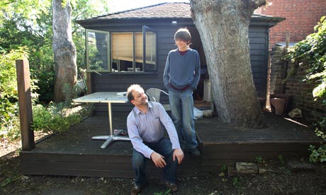 Matthew Norman outside his shed with his son Louis. Photograph: Frank Baron for the Guardian